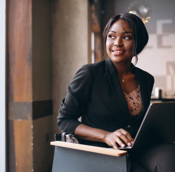 African american business woman working on a computer in a bar